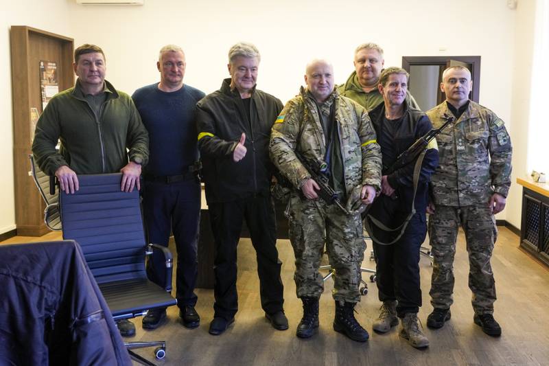 1. Petro Poroshenko - The former Ukrainian president, seen above, third left, at City Hall in Kiev, has been pictured holding a Kalashnikov and surrounded by militia. AP