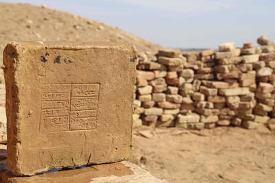 A mud brick bearing a cuneiform inscription found during the Girsu Project's excavation at the ancient Sumerian city, now known as Tello, in Iraq in 2021. Recent excavations of the ancient complex have shed new light on the history and development of the city. AFP