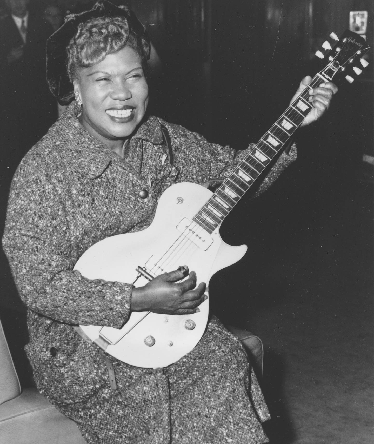 FILE- In this Nov. 21, 1957, file photo, Sister Rosetta Tharpe, guitar-playing American gospel singer, gives an inpromptu performance in a lounge at London Airport, following her arrival from New York. Tharpe, who died in 1973, will be inducted with the â€œAward for Early Influence" to the Rock and Roll Hall of Fame on April 14, 2018 in Cleveland, Ohio. (AP Photo, File)