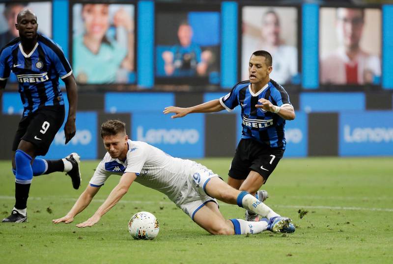 Brescia's Alessandro Semprini, centre, challenges for the ball with Inter Milan's Alexis Sanchez. AP Photo
