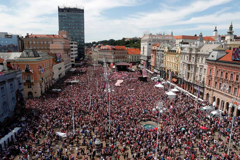 Supporters of Croatia cheer while waiting for the arrival of the Croatian national football team in central Zagreb. Antonio Bat / EPA