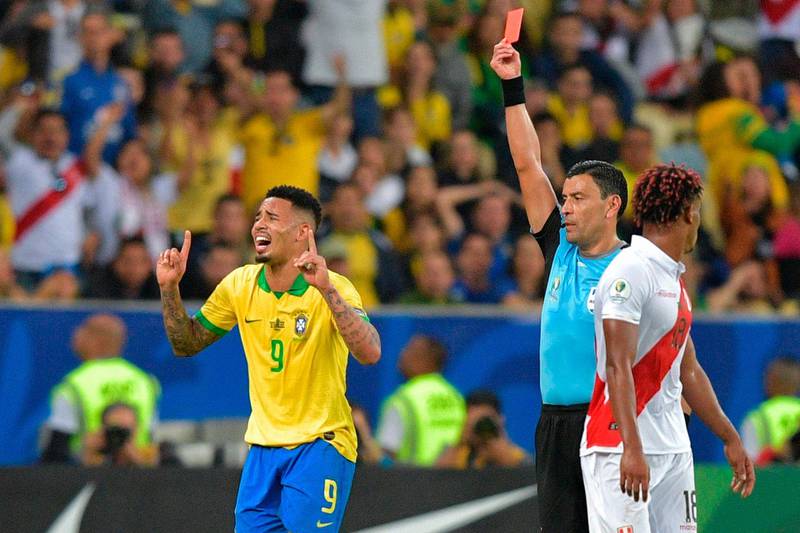 Chilean referee Roberto Tobar shows the red card to Brazil's Gabriel Jesus after a second yellow. AFP