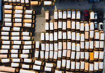 Unused school buses fill a bus company parking lot in the Bronx, New York. EPA