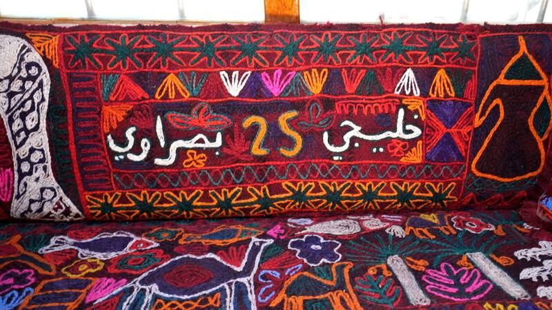 The seats are covered with flat-woven kilims prepared by Iraqi female farmers from the southern province of Samawa, with sayings such as 'You are welcome' and 'Our Gulf is one'

