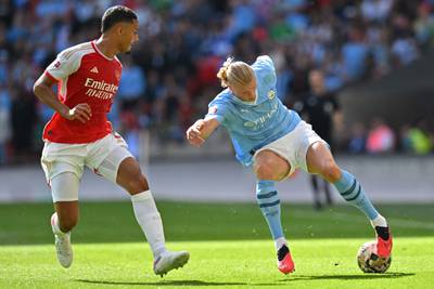 Manchester City's Erling Haaland under pressure from Arsenal's William Saliba. AFP