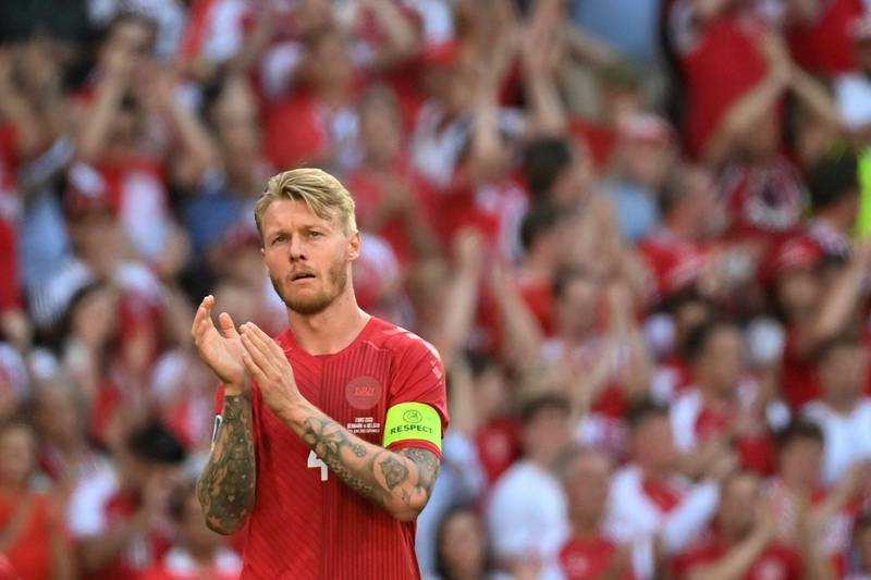 Denmark's defender Simon Kjaer claps after the ball was kicked out of play in honour of Denmark's midfielder Christian Eriksen. AFP