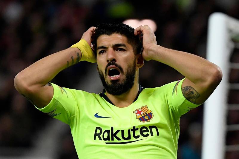 In this file photo taken on April 10, 2019 Barcelona's Uruguayan forward Luis Suarez reacts to missing a shot on goal during the Champions League match against Manchester United at Old Trafford. Atletico Madrid announced the signing of Suarez late on Wednesday. AFP