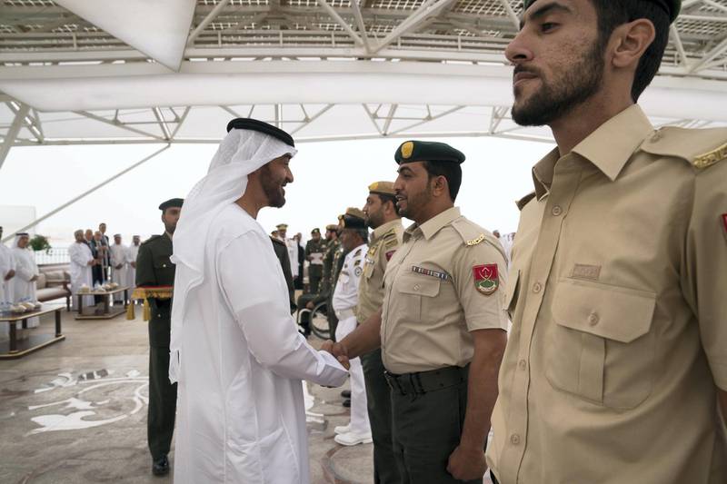 ABU DHABI, UNITED ARAB EMIRATES - April 23, 2018: HH Sheikh Mohamed bin Zayed Al Nahyan Crown Prince of Abu Dhabi Deputy Supreme Commander of the UAE Armed Forces (L), awards a member of the UAE Armed Forces with a Medal of Bravery for his service in Yemen, during a Sea Palace barza.

( Mohamed Al Hammadi / Crown Prince Court - Abu Dhabi )
---