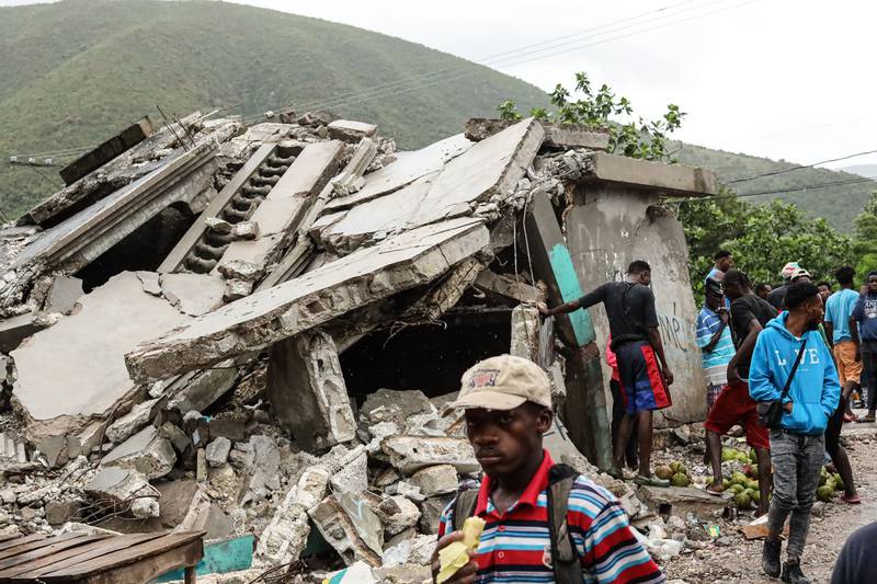 Pedestrians pass in front of a building in ruins, destroyed during the earthquake in Saint-Louis-du-Sud, Haiti, on August 17, 2021. Bloomberg