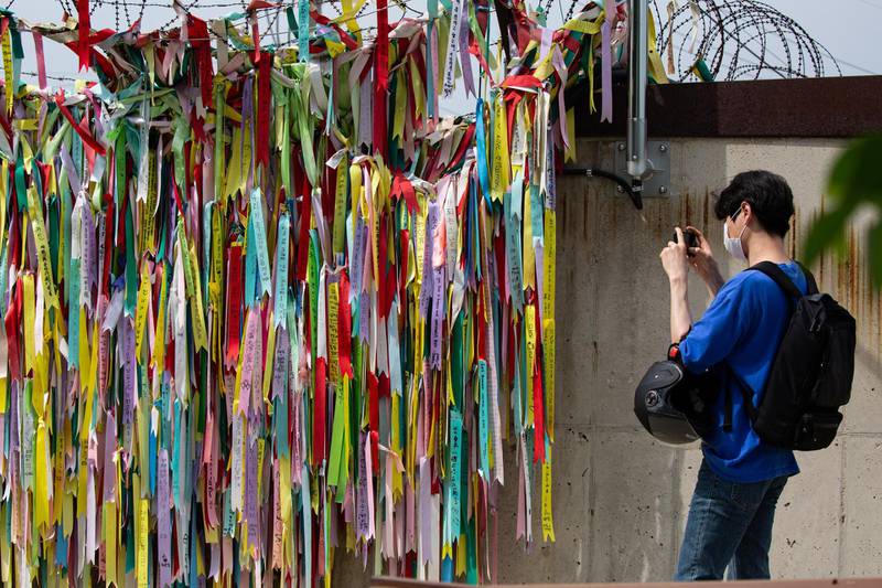 epa08474134 A visitor takes a pictures of the ribbons of peace during an ancestor-memorial service in Imjingak Park, near the Demilitarized Zone (DMZ) in Paju, Gyeonggi-do Province, South Korea, 09 June 2020. North Korea announced on 09 June its decision to disconnect all inter-Korean communications lines, citing anti-Pyongyang leaflets recently sent via balloons by North Korean defectors across the border.  EPA/JEON HEON-KYUN