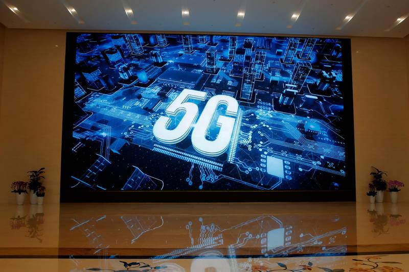 In this March 6, 2019, photo, a 5G logo is displayed on a screen outside the showroom at Huawei campus in Shenzhen city, China's Guangdong province. Australiaâ€™s ban on Chinese telecoms giant Huaweiâ€™s involvement in its future 5G networks and its crackdown on foreign covert interference are testing Beijingâ€™s efforts to project its power overseas. In its latest maneuver, China sent three scholars to spell out in interviews with Australian media and other appearances steps to mend the deepening rift with Beijing - a move that appears to have fallen flat. (AP Photo/Kin Cheung, File)