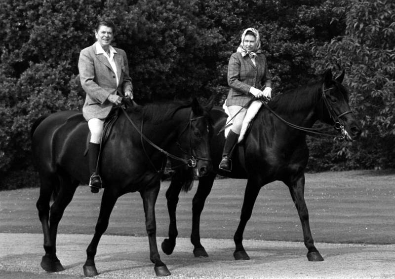 Queen Elizabeth out riding with then-US president Ronald Reagan at Windsor Park. PA
