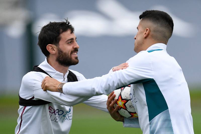 Joao Cancelo and Bernardo Silva have a laugh during training. AFP