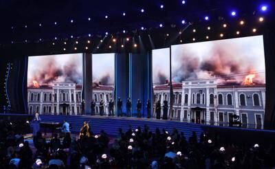 Ukrainian singer Mika Newton performs with John Legend in a tribute to her homeland, ravaged by war with Russia, as images of burning buildings provide a backdrop at the Grammy Awards in Las Vegas. Reuters