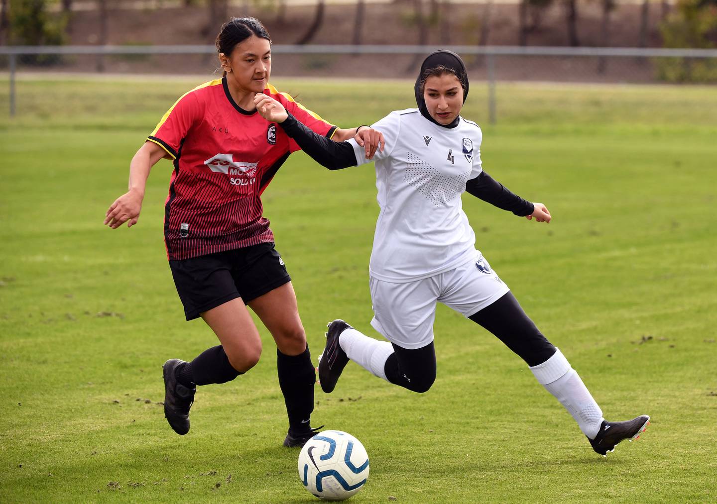 Melbourne Victory Afghan Women's Team player Fatema, right, is tackled during their first match against ETA Buffalo SC in Melbourne. AFP