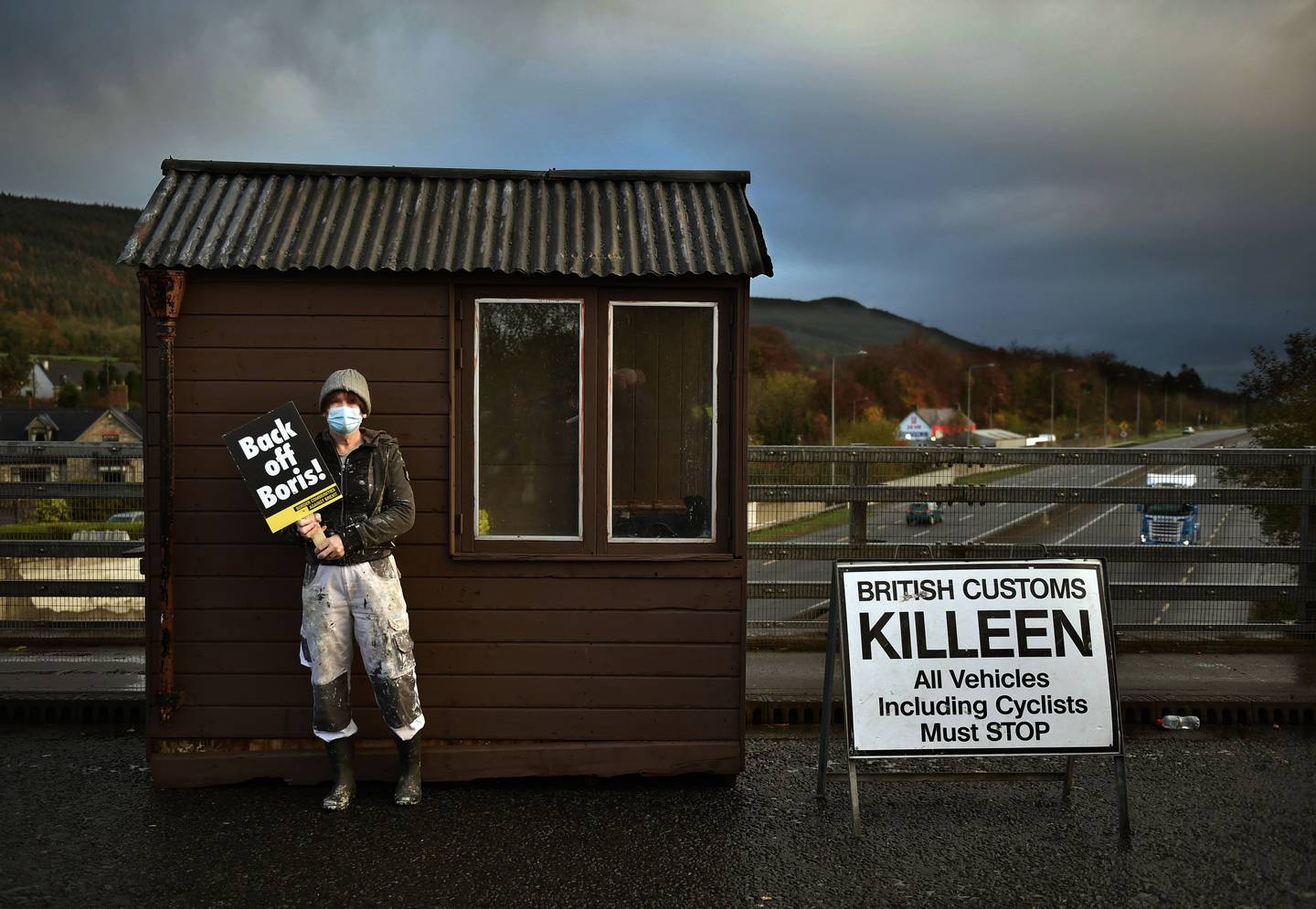 A Border Communities against Brexit protestor stands against a makeshift border customs hut as she takes part in a demonstration in Newry, Northern Ireland. Getty Images