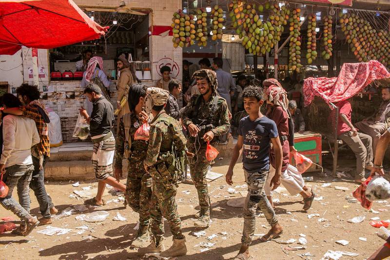 Pro-government fighters walk near the qat market in Marib province. April 3, 2021. Photo/Asmaa Waguih