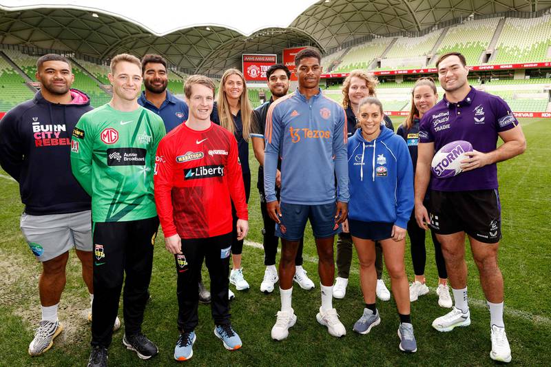 Marcus Rashford poses for a photo with members of various sporting clubs after a press conference in Melbourne. AFP