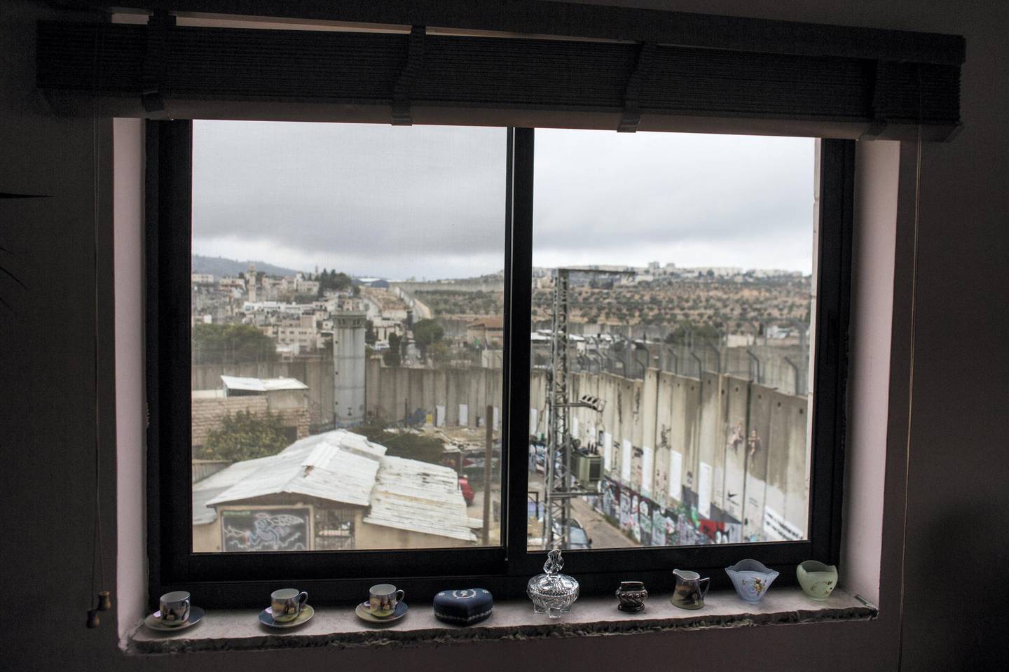 A view from one of the guest rooms at Bansky's ,The Walled-Off hotel in the Palestinian city of Bethlehem on November 24,2018 .The 8 metre-high concrete wall built by Israel is seen from both windows in the room .The hotel boosts that "it has the worst view in the world".Photo by Heidi Levine for The National