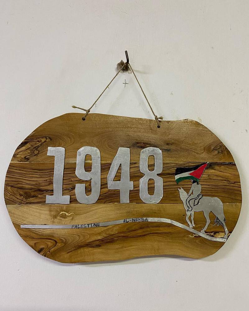 A wall sign made from olive wood to commemorate the 1948 Nakba. Photo: Art48House / Instagram