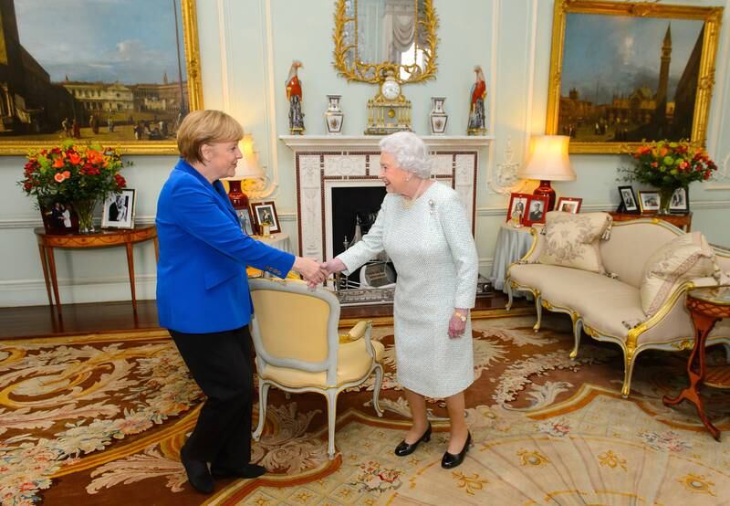 Queen Elizabeth meets former German chancellor Angela Merkel at Buckingham Palace in February 2014. Getty Images