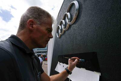 An employee paints at the Audi booth. Audi will be previewing the e-tron quattro concept car at the Frankfurt International Motor Show. Ralph Orlowski / Reuters