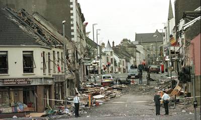 Royal Ulster Constabulary Police officers stand on Market Street after a car bombing in the centre of Omagh in Northern Ireland, in August 1998. AP