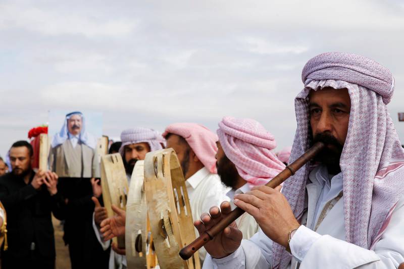 Yazidi musicians play during the funeral of ISIS victims in Kocho. Reuters