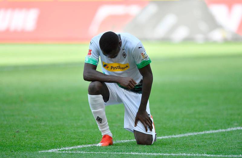 Moenchengladbach's French forward Marcus Thuram takes a knee to show solidarity with protesters in America outraged by the death  of George Floyd, who was killed in a violent police incident in Minneapolis last week. AFP