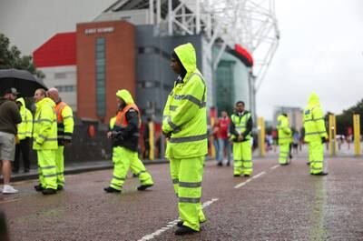 Stewards outside the stadium before the match. Action Images