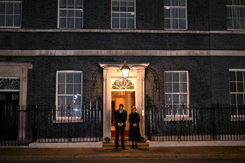 Ms Truss and her husband Hugh O'Leary observe a minute's silence at Number 10 Downing Street following the death of the queen. Reuters