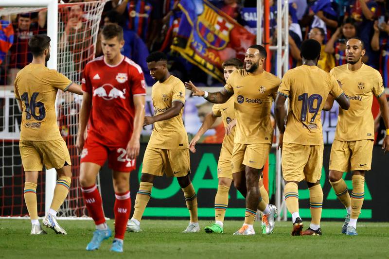 FC Barcelona forward Memphis Depay (C) reacts while being surrounded by his teammates after he scores past the New York Red Bulls defense during the second half of the MLS soccer friendly match between the FC Barcelona and the New York Red Bulls at Red Bulls Arena in Harrison, New Jersey, USA, 30 July 2022.   EPA / JASON SZENES
