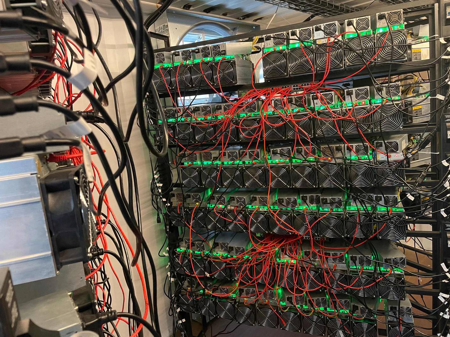 In this photo taken by Matt Lohstroh on May 6, 2021, a bitcoin mining data center is seen on an oil field in North Texas.

 As the value of bitcoin soars and concerns rise about the energy intensive process needed to obtain it, cryptocurrency entrepreneurs in the United States believe they have found a solution in flared natural gas. Profitably creating, or mining, bitcoin and other cryptocurrencies requires masses of computers dedicated to guessing lengthy hexidecimal numbers -- an endeavor that globally consumes more electricity than entire nations, but for which these start-ups say the hydrocarbon-burning torches placed next to oil wells are perfect.
 - RESTRICTED TO EDITORIAL USE - MANDATORY CREDIT "AFP PHOTO / Matt Lohstroh/ HO" - NO MARKETING - NO ADVERTISING CAMPAIGNS - DISTRIBUTED AS A SERVICE TO CLIENTS
 / AFP / Matt Lohstroh / Handout / RESTRICTED TO EDITORIAL USE - MANDATORY CREDIT "AFP PHOTO / Matt Lohstroh/ HO" - NO MARKETING - NO ADVERTISING CAMPAIGNS - DISTRIBUTED AS A SERVICE TO CLIENTS
