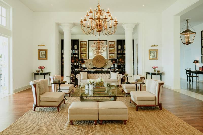 A central living room features sumptuous seating, a library and a baby grand piano. Photo: W15 Hanthana Estate