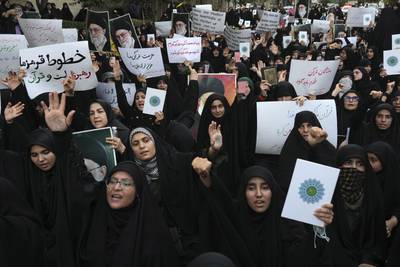 Protesters chant slogans against Sweden in front of the embassy in Tehran, Iran. The Farsi placard on the left reads: "Our red lines are the supreme leader and the Quran". AP