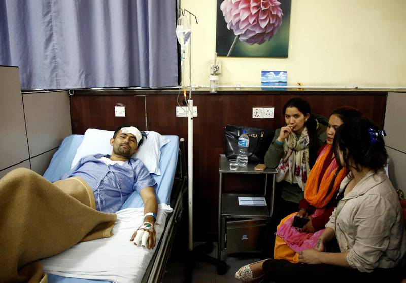 Basanta Bohara, 27, a survivor from the US-Bangla plane crash lies on a hospital bed while undergoing treatment in Kathmandu, Nepal. Navesh Chitrakar / Reuters