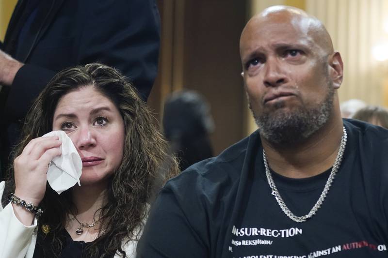 Sandra Garza, the long-time partner of Capitol Hill police officer Brian Sicknick who died shortly after the attack, sits with Capitol police Sgt Harry Dunn. AP