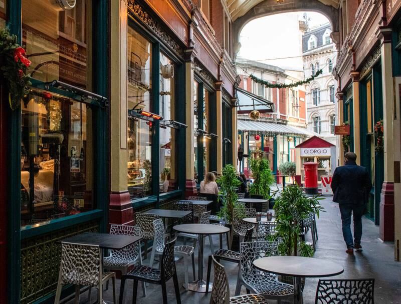 Empty tables in Leadenhall Market in London, where new restrictions are now in place to slow the spread of the Omicron variant of coronavirus. Getty Images