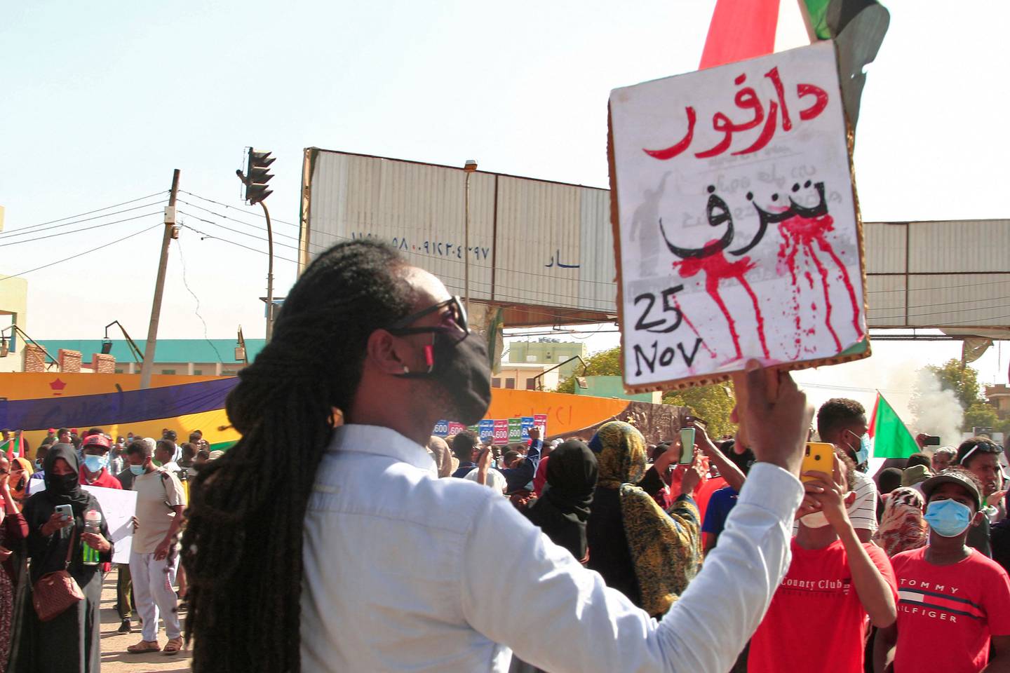 A demonstrator holds a sign reading 'Darfur is bleeding' during a protest demanding civilian rule in the Sudanese capital's twin city of Omdurman. Photo: AFP