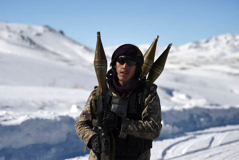 In this photo taken on January 9, 2021, a Hazara armed militia for the Resistance for Justice Movement, holds a rocket-propelled grenade (RPG) as he walks along a road during a patrol against Taliban insurgents at Hisa-e-Awali Behsud district of Maidan Wardak Province. - Comprising roughly 10 to 20 percent of Afghanistan's 38-million population, Hazaras have long been persecuted for their largely Shiite faith by Sunni hardliners in a country wracked by deep ethnic divisions. (Photo by WAKIL KOHSAR / AFP) / TO GO WITH'Afghanistan-Hazara-violence', by David STOUT, Najiba NOORI