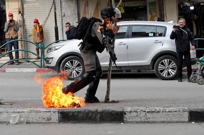 An Israeli border policeman is on fire as he is hit with a molotov cocktail thrown by Palestinian demonstrators during a protest against the U.S. President Donald Trump's Middle East peace plan, in Hebron in the Israeli-occupied West Bank. REUTERS