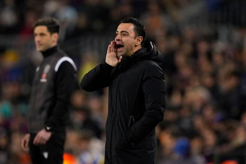 Barcelona manager Xavi Hernandez issues instructions from the touchline during the match against Sevilla. EPA