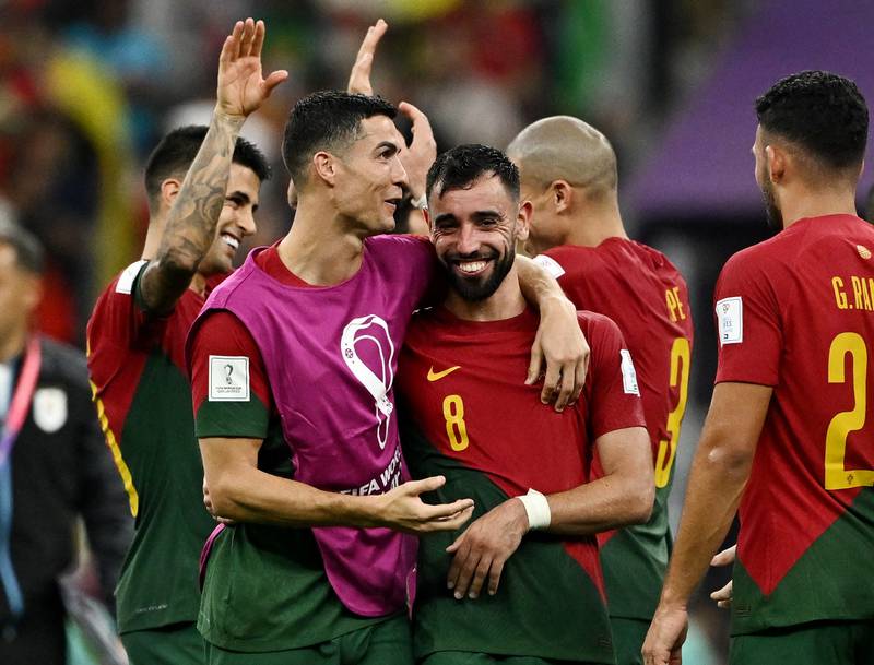 Portugal's Cristiano Ronaldo and Bruno Fernandes celebrate after their 2-0 win in the World Cup Group H game against Uruguay at Lusail Stadium on November 28, 2022. Reuters