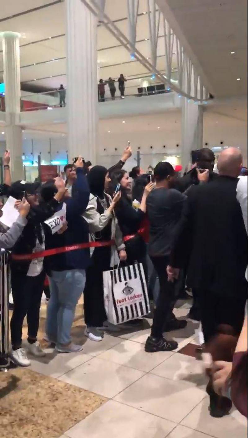 Fans wait for the arrival of Korean boy band Exo at the Dubai International Airport.