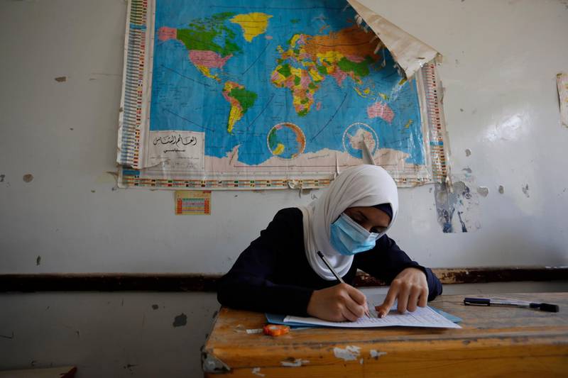 A Yemeni student wearing a protective face mask takes final school exams, after five months of closure due to the coronavirus pandemic, at a public school in Sanaa, Yemen.  EPA
