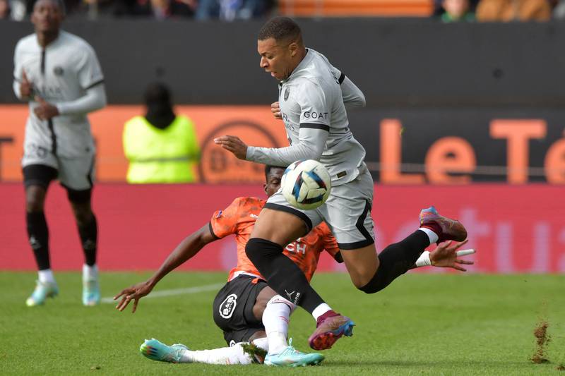 Lorient's Burkinabe forward Dango Ouattara fights for the ball with Paris Saint-Germain's French forward Kylian Mbappe. AFP