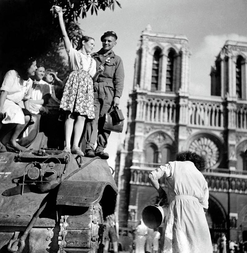 FRANCE - AUGUST 25:  World War II. Liberation of Paris on August 25, 1944, 7a.m. in front of the Cathedral of Notre-Dame. On the tank, Michel Frys, who was later wounded by an ambushed German.  (Photo by Gaston Paris/Roger Viollet/Getty Images)