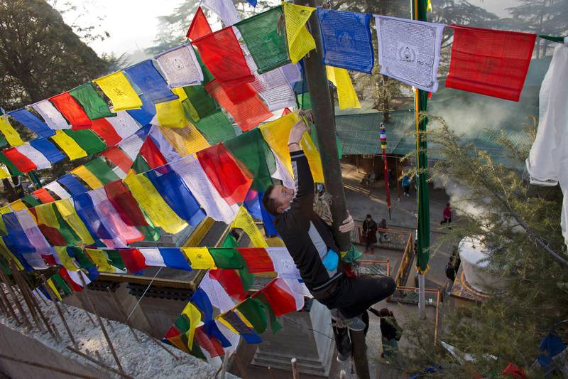 An exiled Tibetan ties multicoloured prayer flags called lungta, or wind horse, on a high pole on the third day of the Tibetan New Year in Dharmsala, India. Tibetans believe that the prayers inscribed on these flags representing the five elements, earth, fire, water, space and air, are spread on wind. Ashwini Bhatia / AP Photo