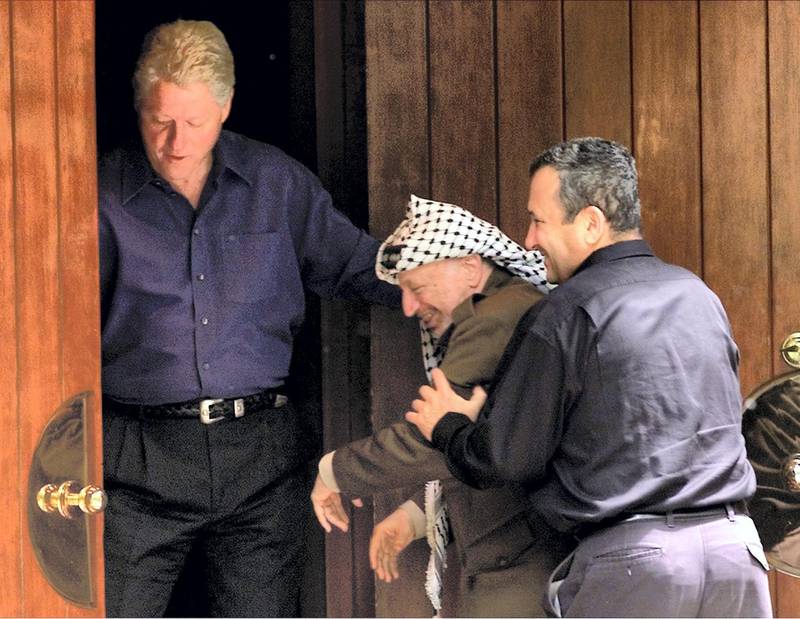 Israeli Prime Minister Ehud Barak (R) jokingly pushes Palestinian President Yasser Arafat (C) into the Laurel cabin on the grounds of Camp David as U.S. President Bill Clinton watches during peace talks, July 11. Arafat and Barak were insisting that the other proceed through the door first. Camp David is the venue where Egypt and Israel made peace in September 1978, and the Laurel cabin was the site of many of the meetings.

WM/RCS