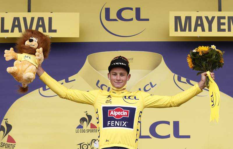 Alpecin–Fenix rider Mathieu van der Poel of the Netherlands celebrates on the podium wearing the yellow jersey after stage 5. Reuters
